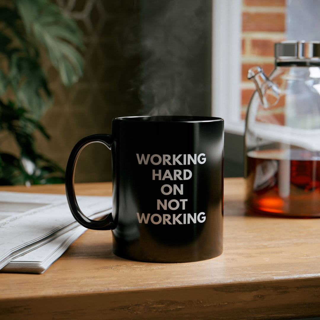 Working Hard on Not Working – Black Mug
